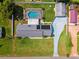 Aerial view featuring a home with a screened pool, solar panels, expansive yard, and long driveway at 2013 Capri Rd, Valrico, FL 33594
