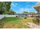 The backyard features a screened pool area with ample green space and manicured landscaping, ideal for recreation at 2013 Capri Rd, Valrico, FL 33594