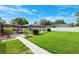 A well-maintained backyard features a screened pool area, lush lawn, and attractive landscaping for outdoor living at 2013 Capri Rd, Valrico, FL 33594
