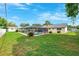 A spacious backyard with a screened pool, lush green grass, and manicured landscaping for outdoor enjoyment at 2013 Capri Rd, Valrico, FL 33594