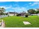 This large backyard features a screened pool area with mature trees, a spacious lawn, and ample room to roam at 2013 Capri Rd, Valrico, FL 33594