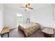 This bedroom features a ceiling fan, window, and carpeted floors at 2013 Capri Rd, Valrico, FL 33594