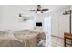 Bright bedroom features tile floors, a ceiling fan, and a large window at 2013 Capri Rd, Valrico, FL 33594