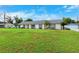 Charming single-story home with spacious front yard, detached garage, and manicured lawn at 2013 Capri Rd, Valrico, FL 33594