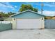 This clean two-car garage features a white door, brick accents, and well-maintained landscaping for a welcoming curb appeal at 2013 Capri Rd, Valrico, FL 33594
