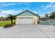 This two-car garage offers ample storage and parking space with a well-manicured lawn and easy access at 2013 Capri Rd, Valrico, FL 33594