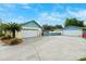 A long driveway leads to two garages, offering ample parking and storage space on a well-maintained lot at 2013 Capri Rd, Valrico, FL 33594