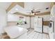Bright kitchen featuring white cabinets, ample counter space, and a convenient breakfast bar at 2013 Capri Rd, Valrico, FL 33594