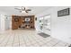 Cozy living room featuring a brick fireplace, tiled floors, and glass doors to bring in natural light at 2013 Capri Rd, Valrico, FL 33594