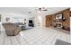 Spacious living room with tiled floors and a brick fireplace, perfect for relaxing and entertaining at 2013 Capri Rd, Valrico, FL 33594