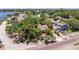 Aerial view showcasing the home, lush landscaping, and street, nestled among mature trees in the neighborhood at 202 39Th S Ave, St Petersburg, FL 33705
