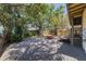 Spacious backyard featuring a shed, mature trees, and a picnic table on a gravel surface at 202 39Th S Ave, St Petersburg, FL 33705