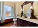 Charming bathroom features a clawfoot tub and a vanity with an ornate mirror and marble countertop at 202 39Th S Ave, St Petersburg, FL 33705
