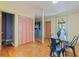 Dining room with wood floors, glass table, and a view into another room through an open doorway at 202 39Th S Ave, St Petersburg, FL 33705