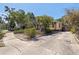 Property exterior view showcasing a driveway, mature trees, and lush landscaping, adding to the home's charm at 202 39Th S Ave, St Petersburg, FL 33705