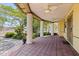 Inviting front porch with tiled flooring, ceiling fans and sturdy columns, perfect for relaxing at 202 39Th S Ave, St Petersburg, FL 33705