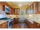 Charming kitchen features wood cabinets, stainless steel appliances, breakfast bar, and farmhouse sink at 202 39Th S Ave, St Petersburg, FL 33705