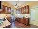 Charming kitchen boasts wood cabinets, stainless appliances, farmhouse sink, breakfast bar, and tile floors at 202 39Th S Ave, St Petersburg, FL 33705