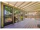 Covered patio overlooking a fenced-in backyard, featuring wood decking and screened windows at 202 39Th S Ave, St Petersburg, FL 33705