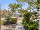 Charming property with a well-maintained sidewalk, lush greenery, and a glimpse of the inter coastal waterway at 202 39Th S Ave, St Petersburg, FL 33705