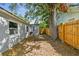 Large backyard with shade trees and a wooden privacy fence at 2230 Melrose S Ave, St Petersburg, FL 33712