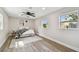 Bright bedroom featuring wood-look flooring, a ceiling fan, and two windows at 2230 Melrose S Ave, St Petersburg, FL 33712