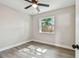 Bright bedroom with neutral paint, ceiling fan, and wood-look floors with natural light at 2230 Melrose S Ave, St Petersburg, FL 33712