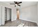 Bedroom with a closet, a ceiling fan, neutral paint, and wood-look floors at 2230 Melrose S Ave, St Petersburg, FL 33712