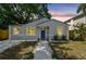 Charming bungalow-style home with blue door, fresh landscaping, and a welcoming walkway to the entrance at 2230 Melrose S Ave, St Petersburg, FL 33712