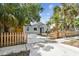 Well-maintained home with a fenced yard and tropical landscaping, showcasing curb appeal at 2230 Melrose S Ave, St Petersburg, FL 33712