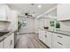 Open-concept kitchen with island, stainless appliances, granite countertops, and view to the dining area at 2230 Melrose S Ave, St Petersburg, FL 33712