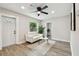 Cozy living room featuring neutral decor, a comfortable white sofa, and modern ceiling fan at 2230 Melrose S Ave, St Petersburg, FL 33712