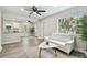 Open living area with a glimpse of the kitchen, featuring wood-look floors and natural light at 2230 Melrose S Ave, St Petersburg, FL 33712