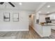 Open-concept living space with sleek floors, neutral walls, and a breakfast bar connecting to the kitchen at 2230 Melrose S Ave, St Petersburg, FL 33712