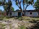 Backyard of home with a white exterior, mature trees, and plenty of room at 2254 66Th S Ave, St Petersburg, FL 33712