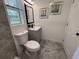 Bathroom features a modern vanity, framed mirror, and decorative wall art at 2254 66Th S Ave, St Petersburg, FL 33712