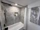 Modern bathroom featuring a bathtub and shower with elegant marble tiling and updated fixtures at 2254 66Th S Ave, St Petersburg, FL 33712