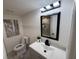 Stylish bathroom featuring a modern vanity, sleek black fixtures, and elegant lighting above the mirror at 2254 66Th S Ave, St Petersburg, FL 33712