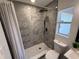 Modern bathroom with tiled shower, rainfall shower head, and pebble floor, offering a spa-like experience at 2254 66Th S Ave, St Petersburg, FL 33712