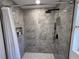 Modern bathroom featuring a walk-in shower with elegant gray marble tiling and updated fixtures at 2254 66Th S Ave, St Petersburg, FL 33712