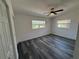 Bedroom featuring wood-look flooring, fan, and natural light from two windows at 2254 66Th S Ave, St Petersburg, FL 33712