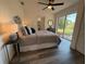 Serene bedroom featuring wood floors, a large window and a view into an attached bathroom at 2254 66Th S Ave, St Petersburg, FL 33712