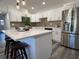 Modern kitchen with stainless steel appliances, quartz countertops, an island, and stylish pendant lighting at 2254 66Th S Ave, St Petersburg, FL 33712