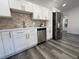 Modern kitchen features stainless steel appliances, custom backsplash, and light colored countertops at 2254 66Th S Ave, St Petersburg, FL 33712