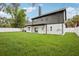 Back of the home with a spacious lawn, showing a modern two-story architecture and fenced yard at 226 Willowick Ave, Temple Terrace, FL 33617