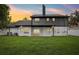 Back exterior featuring a well-maintained lawn, modern two-story architecture, and a beautiful sunset at 226 Willowick Ave, Temple Terrace, FL 33617
