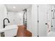 Basement featuring a modern wash basin, a spiral staircase, and tile and hardwood floors at 226 Willowick Ave, Temple Terrace, FL 33617