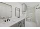 Updated bathroom features double sinks, gray cabinetry and a walk-in shower at 226 Willowick Ave, Temple Terrace, FL 33617