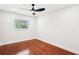 Bedroom with hardwood floors, white walls, and a window letting in natural light at 226 Willowick Ave, Temple Terrace, FL 33617