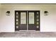 Elegant double front doors with glass panels and stylish outdoor lighting fixtures at 226 Willowick Ave, Temple Terrace, FL 33617